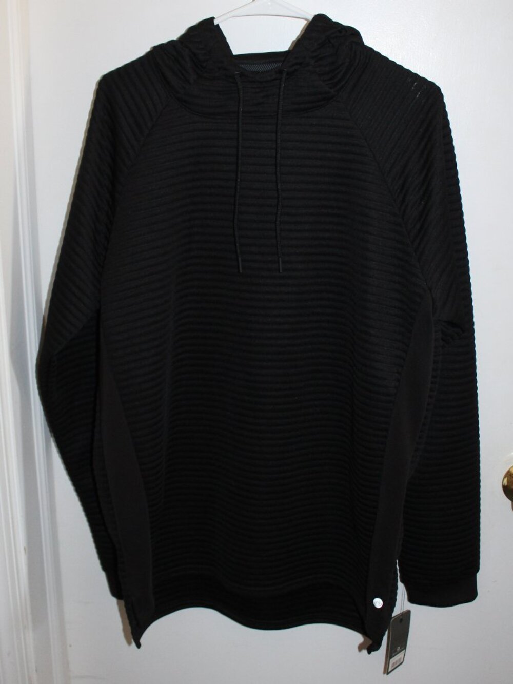 Black Apana Men's Ottoman Hoodie features a textured, ribbed fabric design.